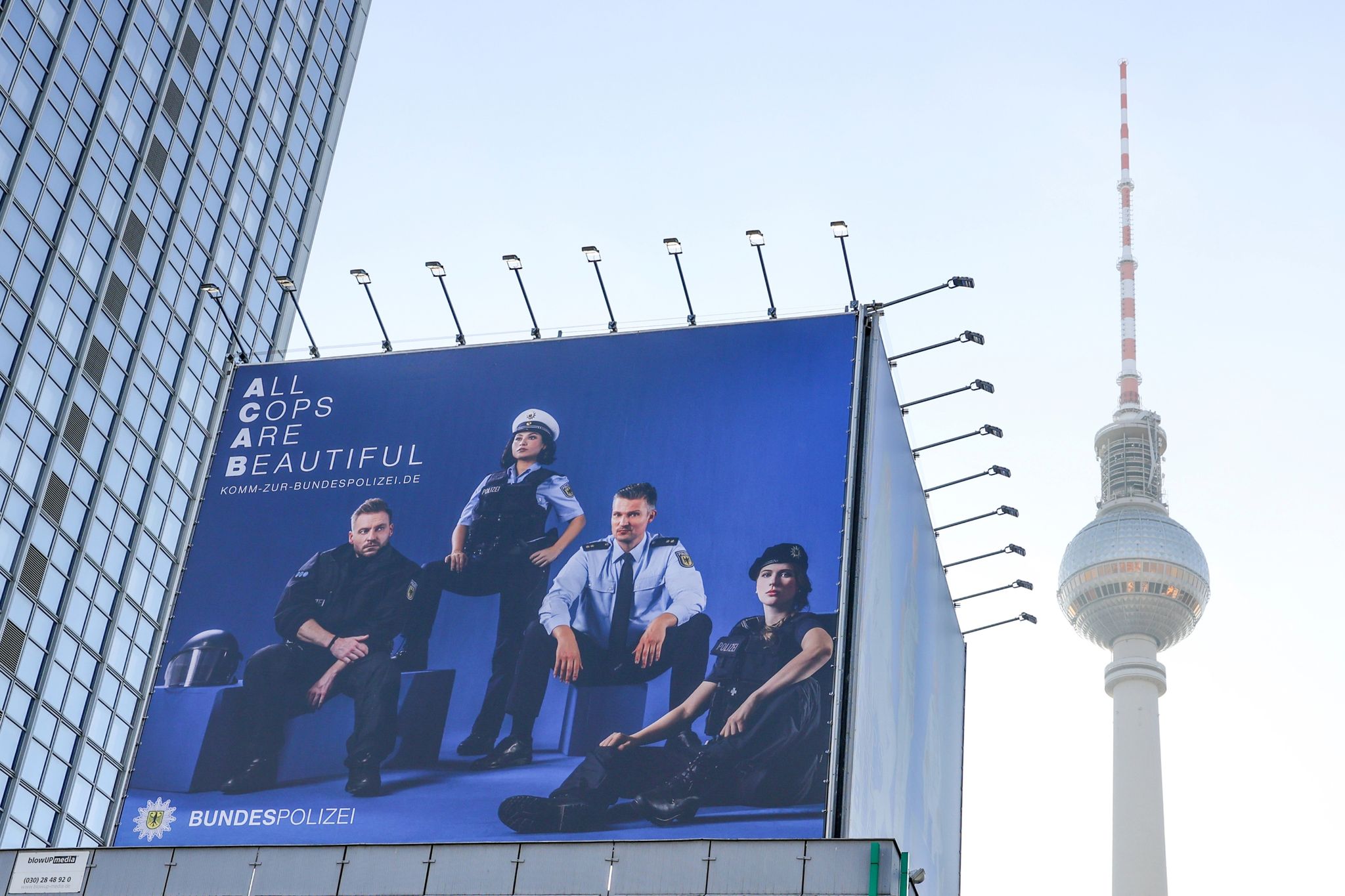 Mit einem riesigen Transparent und der Aufschrift «All Cops Are Beautiful» (Alle Polizisten sind schön) wirbt die Bundespolizei in Sichtweite des Fernsehturms um Nachwuchs. (© Jörg Carstensen/dpa)